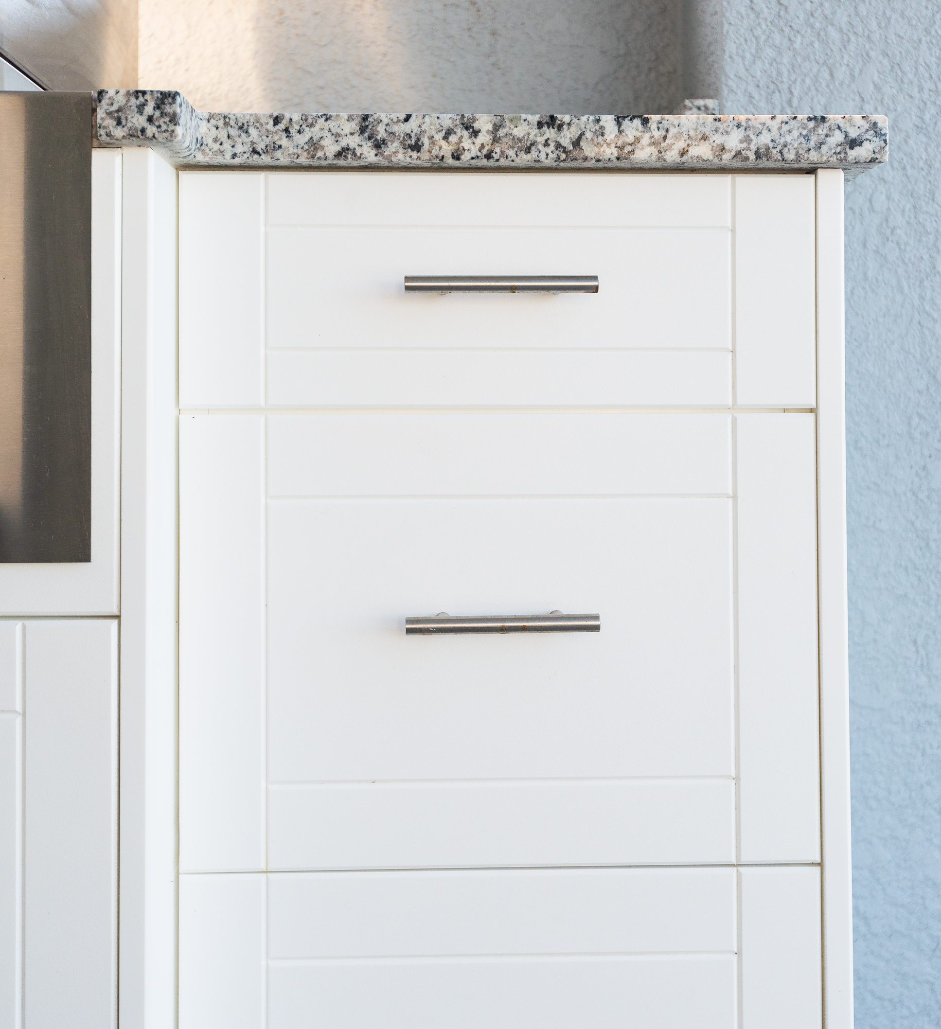a white cabinet with a marble top