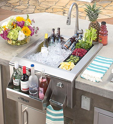 Outdoor beverage sink with ice, drinks, and fresh garnishes