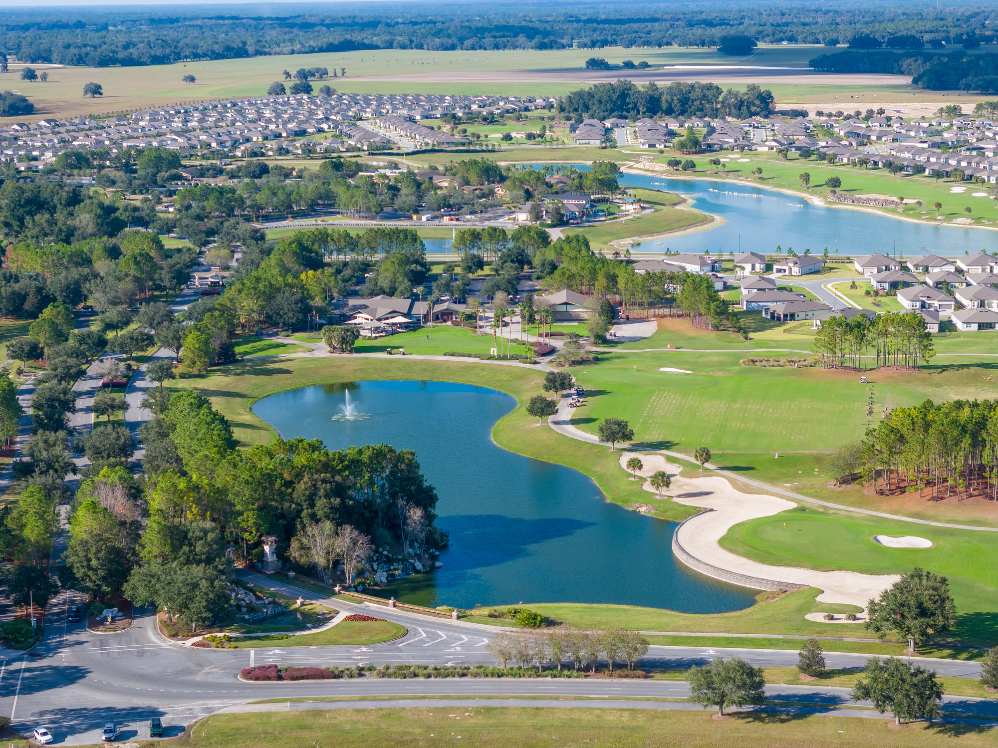 Aerial view of Bradenton Florida neighborhood with lakes, golf course, and residential homes.