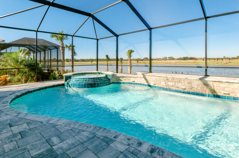 Luxury custom pool with spa and water features overlooking a Florida lake.